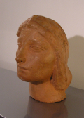 
															Portrait de jeune femme en terre cuite vers 1905 - 1910
														